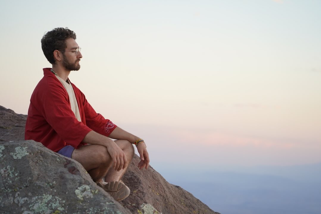 Matthew seated outdoors